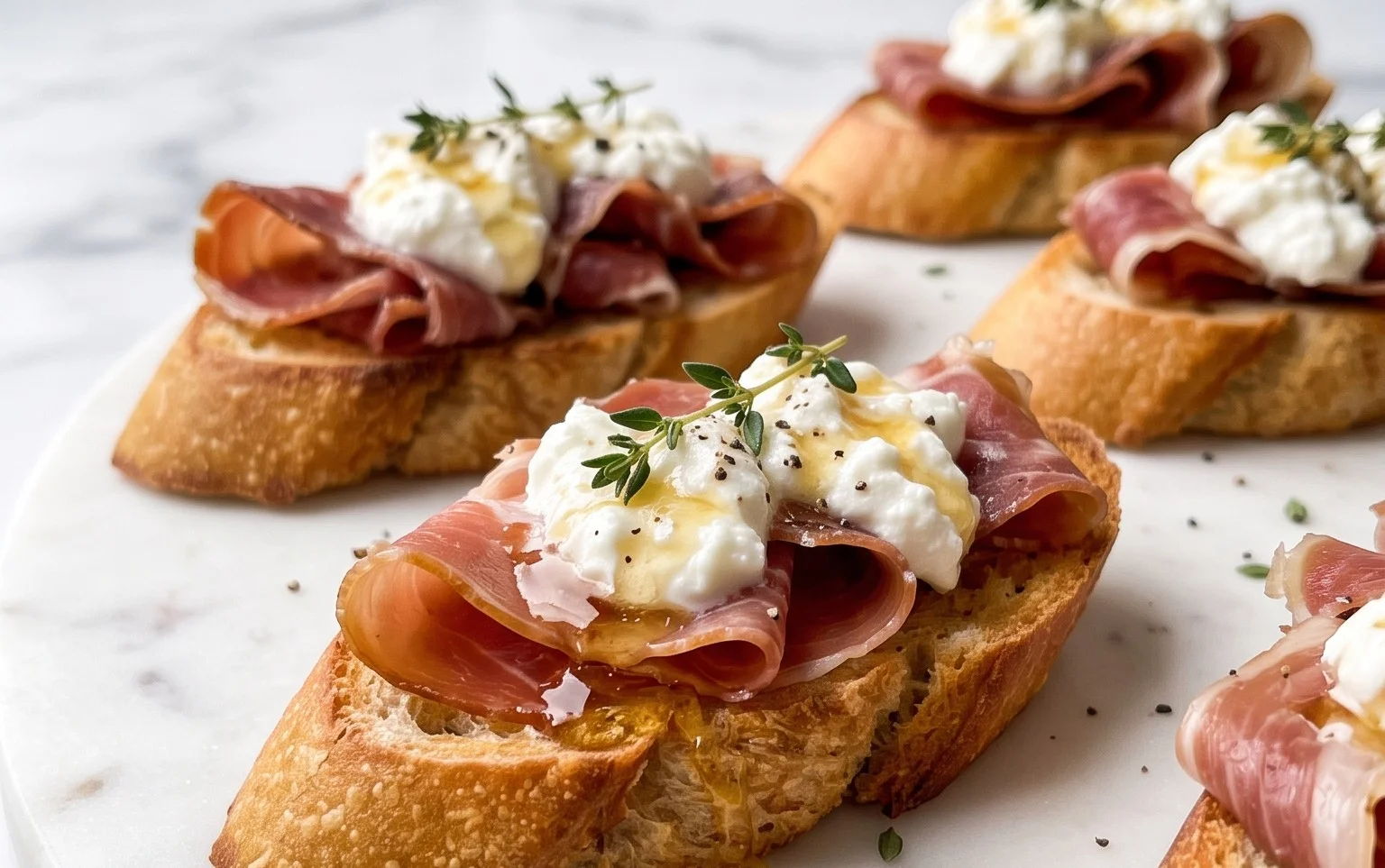 Beef Prosciutto Crostini with Burrata and Lemon Honey Drizzle